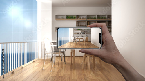 Hand holding smart phone, AR application, simulate furniture and ... Hand holding smart phone, AR application, simulate furniture and ...