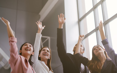 Successful of Business People Celebrating In office. Group of Happy business team hands raised for...