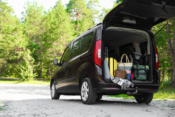 Van with camping equipment in trunk outdoors © New Africa