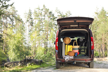 Van with camping equipment in trunk outdoors