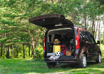 Van with camping equipment in trunk outdoors © New Africa