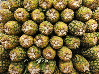 Fototapeta na wymiar Ananas Pineapple fruit in the market. Food background texture.