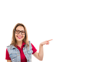 Young cute woman in glasses pointing happily away with finger