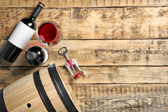 Glassware with red wine on wooden background, top view