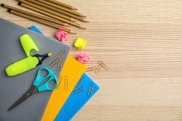 Flat lay composition with different school stationery on wooden background