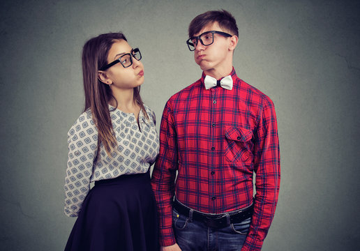 Grumpy couple puffing cheeks in offense