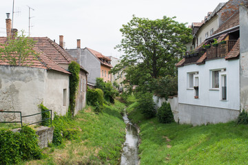 Small stream passing behind houses in the city of Sopron, Hungary