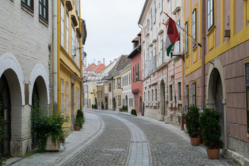 Flags line empty streets in the Old Town of Sopron, Hungary