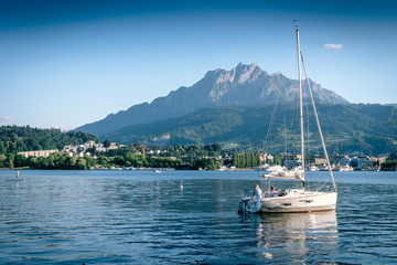 Fototapeta na wymiar Mountain Pilatus and Sailing boat at Luzern, Switzerland, concept of travel vacation to Europe