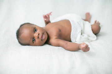 Awake Newborn Baby on Cream White Background