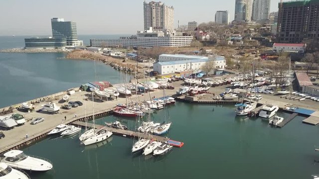 Aerial shooting from drone boat and yacht standing in parking lot in sea port