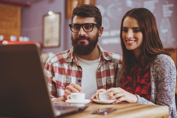 Couple Watching Film in Coffee House.