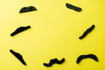 overhead mustache on a yellow background, accessory for a holiday, father's day