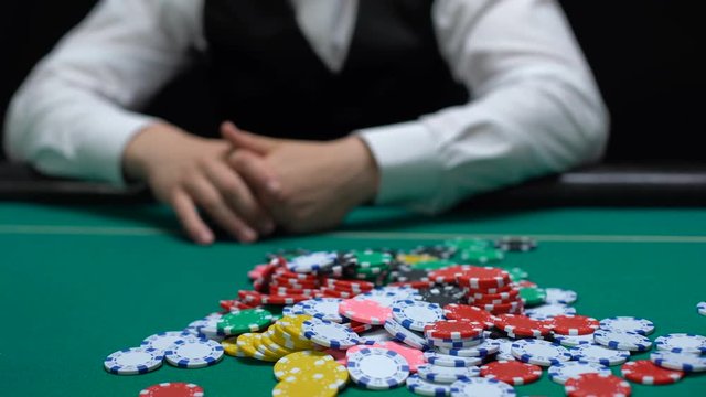 Poker players betting, putting casino chips table, raising, gambling addiction