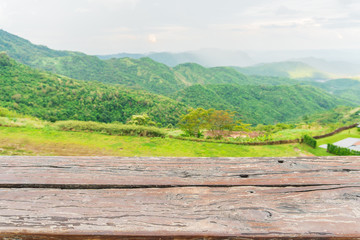 Empty wood table and blur green mountain background