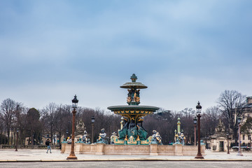 Fototapeta na wymiar Fountain of River Commerce and Navigation at the Place de la Concorde in a cold winter day