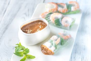Fototapeta na wymiar Shrimp rice paper rolls with peanut sauce