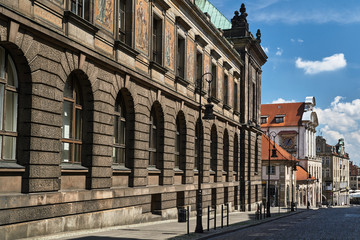 A cobbled street and historic buildings of the Old Town in Poznań.