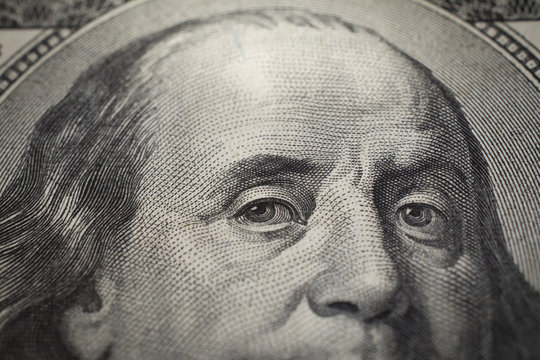 Dollars closeup. Benjamin Franklin's portrait on one hundred dollar bill.