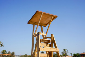 Empty wooden beach guard chair