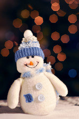 Smilling  handmade snowman with bokeh lights on background. Christmas concept