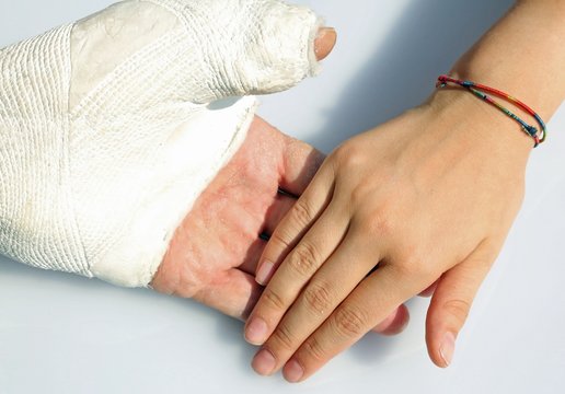 hand of the little girl who gently holds that of her dad after t