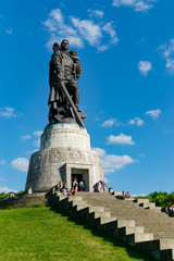 Obraz premium Photo in detail of the Soviet War Memorial in Trepower Park, where a Soviet soldier is seen saving a child. Photograph taken in Berlin, Germany.