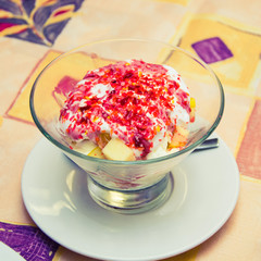 ice cream with berries in a transparent glass on the table