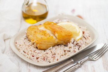 fried cod fish with rice on dish