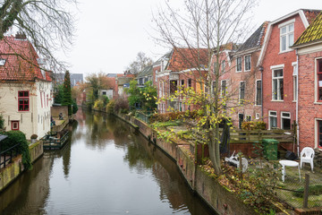Fototapeta na wymiar Houses along the canal Damsterdiep in the Dutch village Appingedam