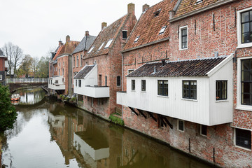 Fototapeta na wymiar The famous hanging kitchens above the canal Damsterdiep in the Dutch village Appingedam