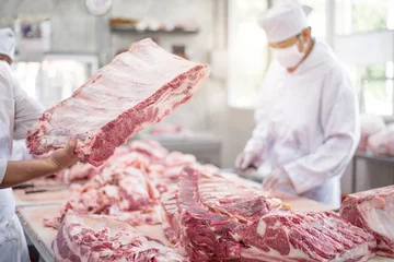 Fotobehang Butcher cutting pork meat food industry concept © bannafarsai