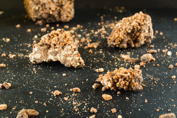 Chocolate with puffed rice and raisins over dark background