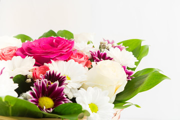 Beautiful flowers bouquet with roses and chrysanthemum in basket