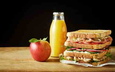 Lunch food set with sandwich, juice and apple