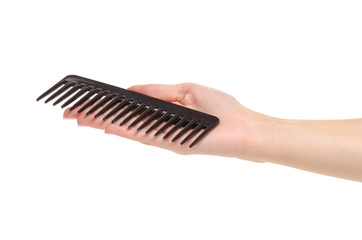 Black hair comb in hand on white background isolation