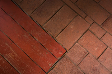 old brick floor with a fragment of a wooden hatch