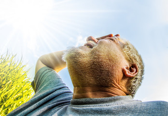 in bright sun and high temperatures, a man sees the sky