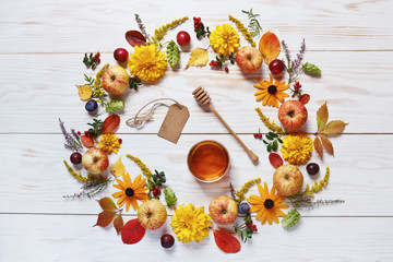 Apples, flowers and honey with copy space form a floral decoration. Concept  for Rosh Hashanah the...
