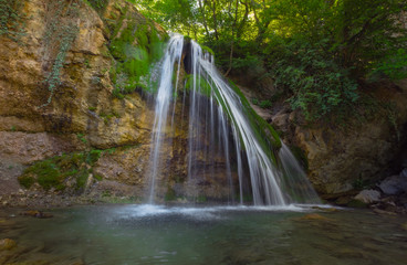 Obraz premium Mountain River with, forest landscape. Tranquil waterfall scenery in the middle of green forest