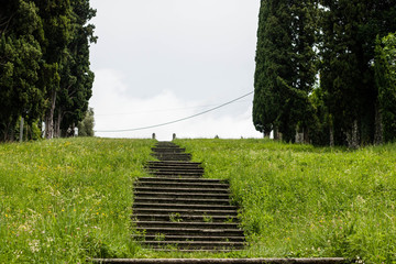 Stairs to the sky - historic stairs climbing up a hill with grass and trees