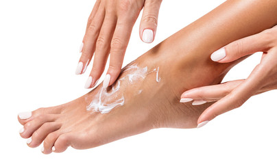 Woman applying cream on her beautiful feet. - 216870975