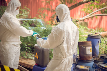 Asian scientist wear Chemical protection suit check danger chemical,working at dangerous...