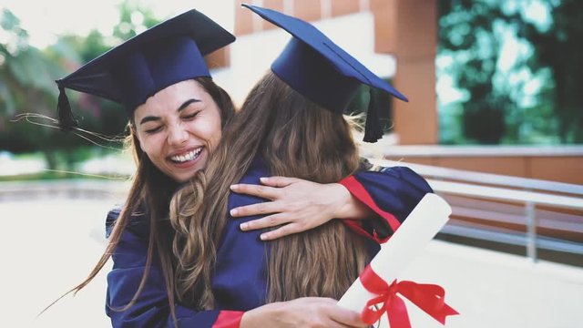 Graduated student hugging her friend