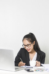 Happy business Asian woman working with laptop at white working table, diligent professional working woman.