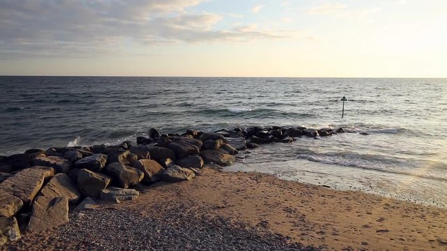 Ocean Waves Crushing Against Stony Breakwater