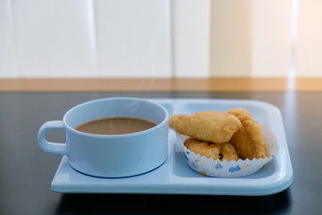 Coffee break set a hot drink cup and snack in paper place on black table for relaxing