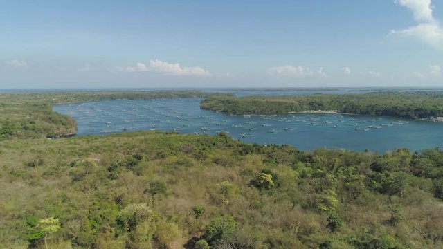 Fish farm with cages for fish and shrimp in the Philippines, Luzon. Aerial view of fish ponds for bangus, milkfish.