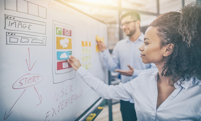 Designers drawing website ux app development.