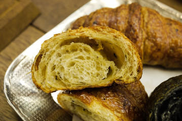 Cross section showing structure of delicious and buttery Truffle Croissants made by pastry chef. All look very tasty and delightful. Natural light. Close up.